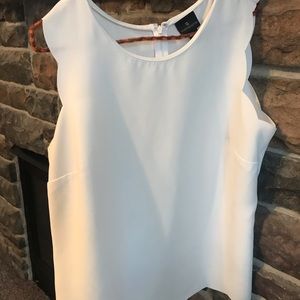 White sleeveless blouse. No stains.